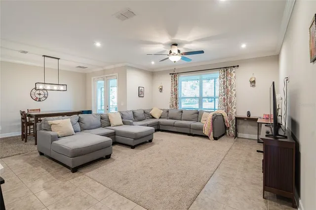 a bedroom with a bed a chandelier and a window