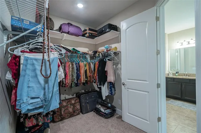 a spacious bathroom with a granite countertop sink a toilet and a mirror