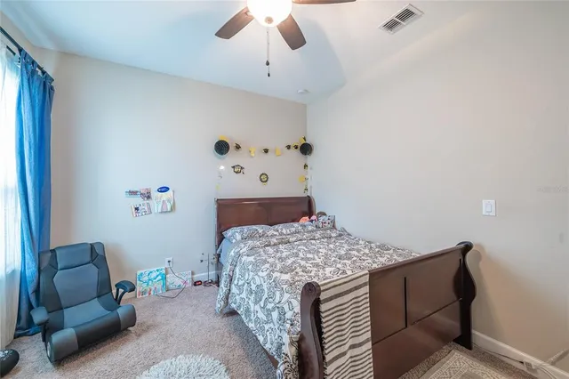 a view of a livingroom with furniture and chandelier fan