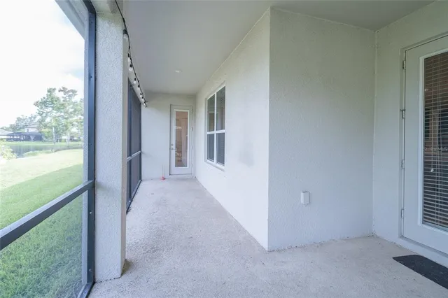 an aerial view of residential houses with outdoor space and swimming pool