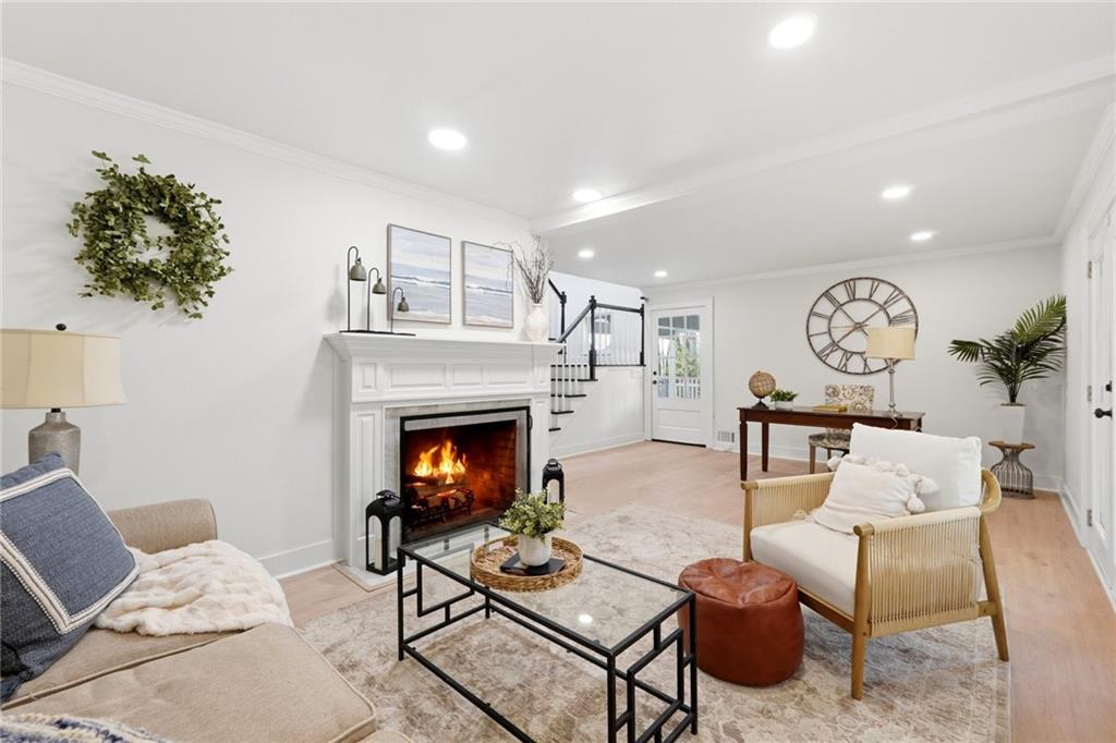 2955 Brookfield Circle Cumming, GA 30040 - Photo 19 of 89 a living room with furniture a fireplace and a potted plant