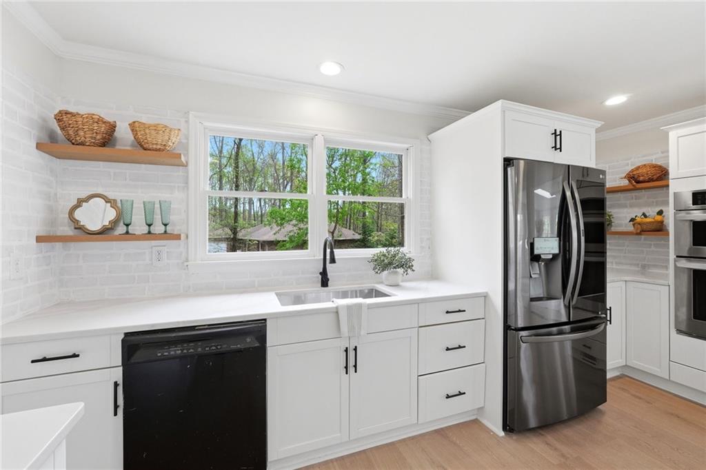 2955 Brookfield Circle Cumming, GA 30040 - Photo 23 of 89 a kitchen with stainless steel appliances a refrigerator sink and cabinets