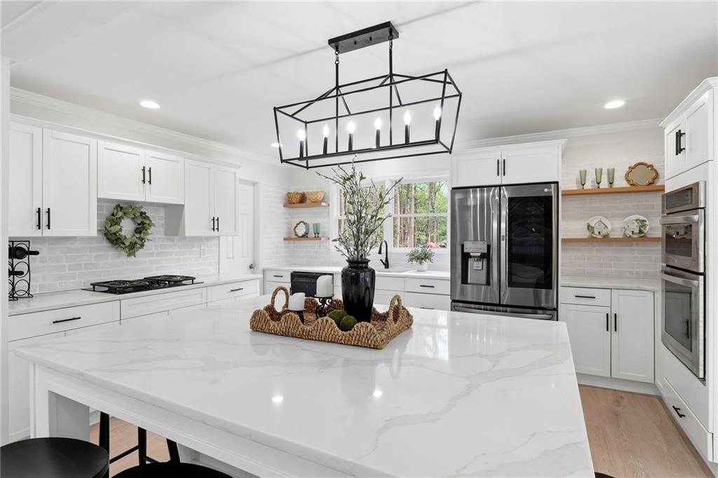 2955 Brookfield Circle Cumming, GA 30040 - Photo 24 of 89 a kitchen with stainless steel appliances granite countertop a stove and refrigerator