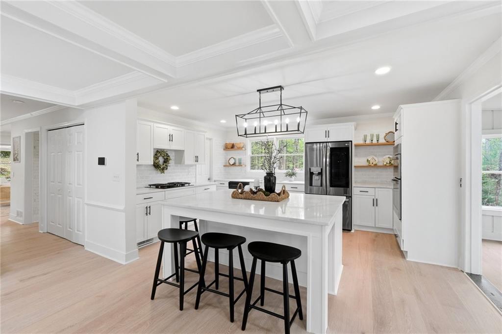 2955 Brookfield Circle Cumming, GA 30040 - Photo 29 of 89 a kitchen with stainless steel appliances a dining table chairs refrigerator and microwave