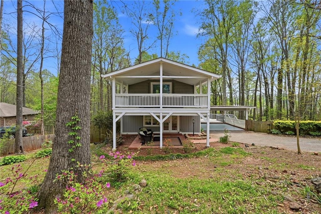 2955 Brookfield Circle Cumming, GA 30040 - Photo 3 of 89 a view of a chair and table in backyard of the house