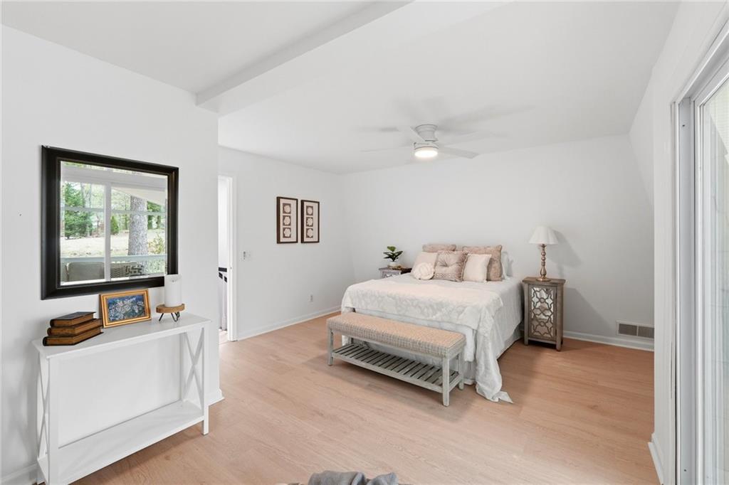 2955 Brookfield Circle Cumming, GA 30040 - Photo 42 of 89 a bedroom with a bed and a flat tv screen on the dresser