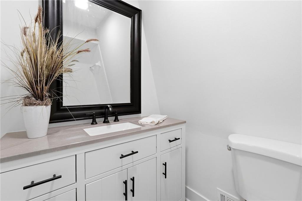 2955 Brookfield Circle Cumming, GA 30040 - Photo 46 of 89 a bathroom with a granite countertop sink and a mirror
