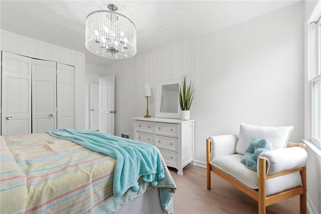 2955 Brookfield Circle Cumming, GA 30040 - Photo 52 of 89 a bedroom with a bed and a chandelier