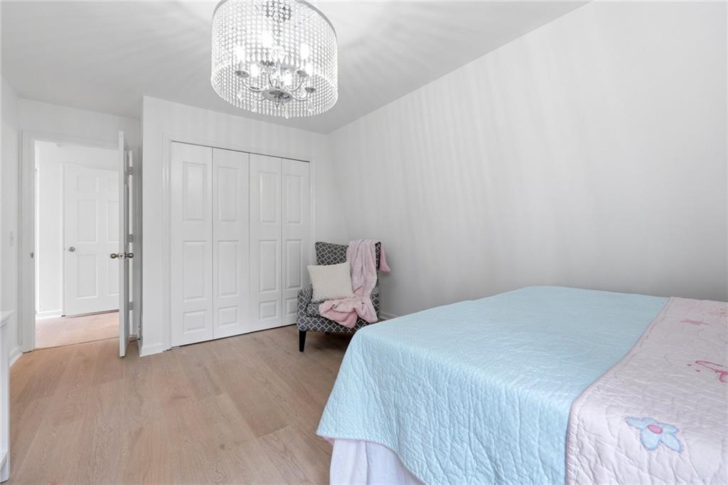 2955 Brookfield Circle Cumming, GA 30040 - Photo 56 of 89 a bedroom with a bed and a chandelier