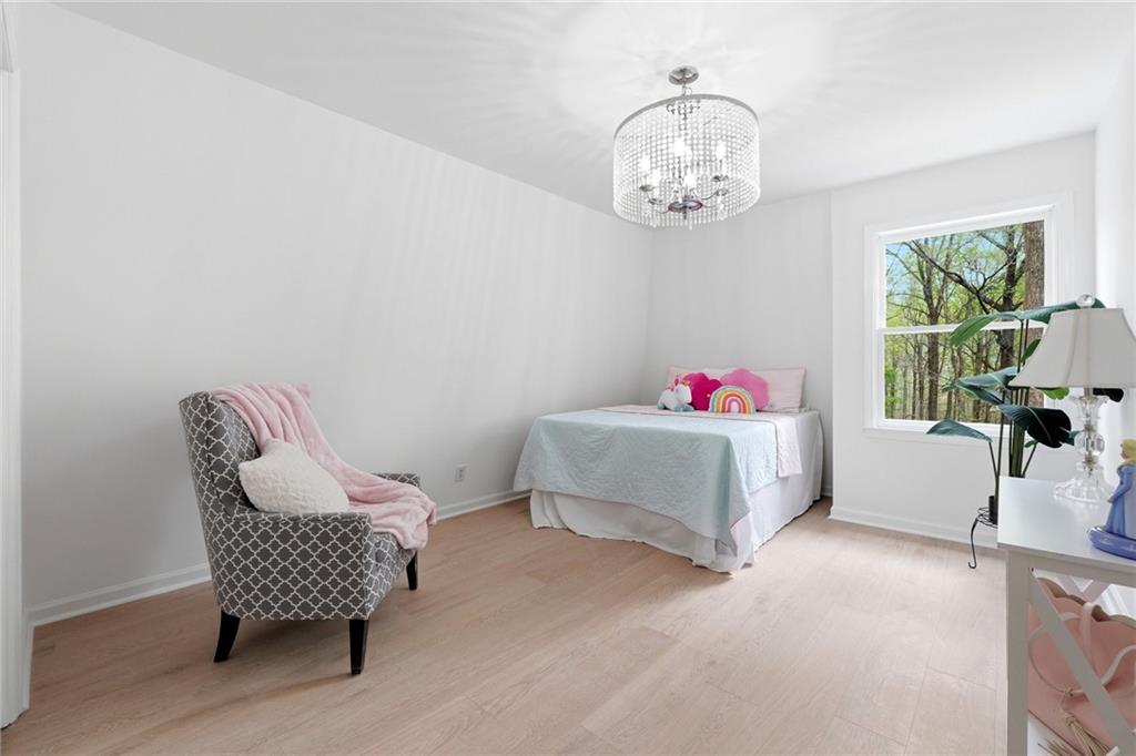 2955 Brookfield Circle Cumming, GA 30040 - Photo 57 of 89 a living room with furniture and a chandelier