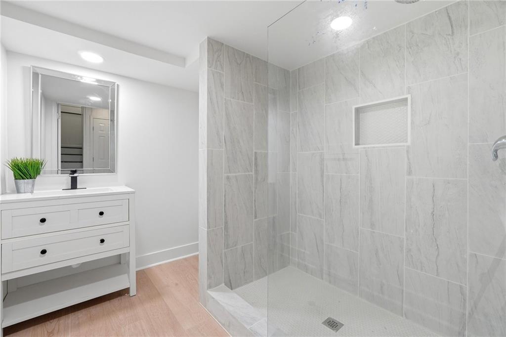 2955 Brookfield Circle Cumming, GA 30040 - Photo 58 of 89 a bathroom with a bathtub a sink and a shower