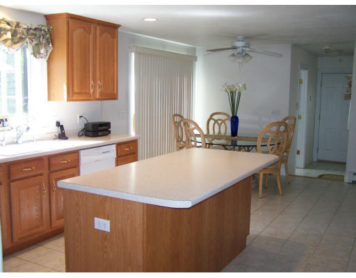 223 County Road Rochester, MA 02576 - Photo 10 of 25 a kitchen with kitchen island a sink table and chairs