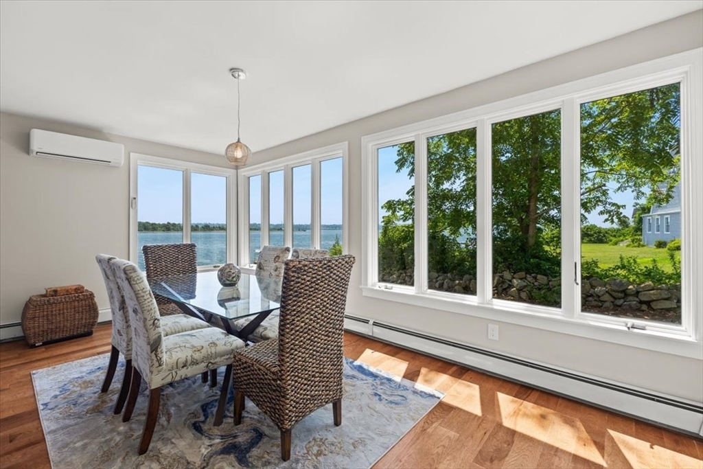 1366 Gardners Neck Road Swansea, MA 02777 - Photo 24 of 35 a view of a dining room with furniture large windows and outside view