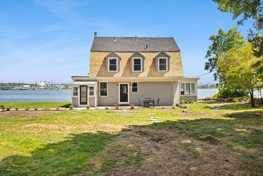 1366 Gardners Neck Road Swansea, MA 02777 - Photo 26 of 35 a front view of a house with a yard