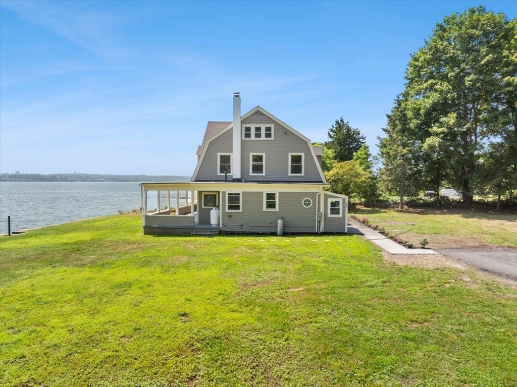 1366 Gardners Neck Road Swansea, MA 02777 - Photo 3 of 35 a front view of a house with a yard