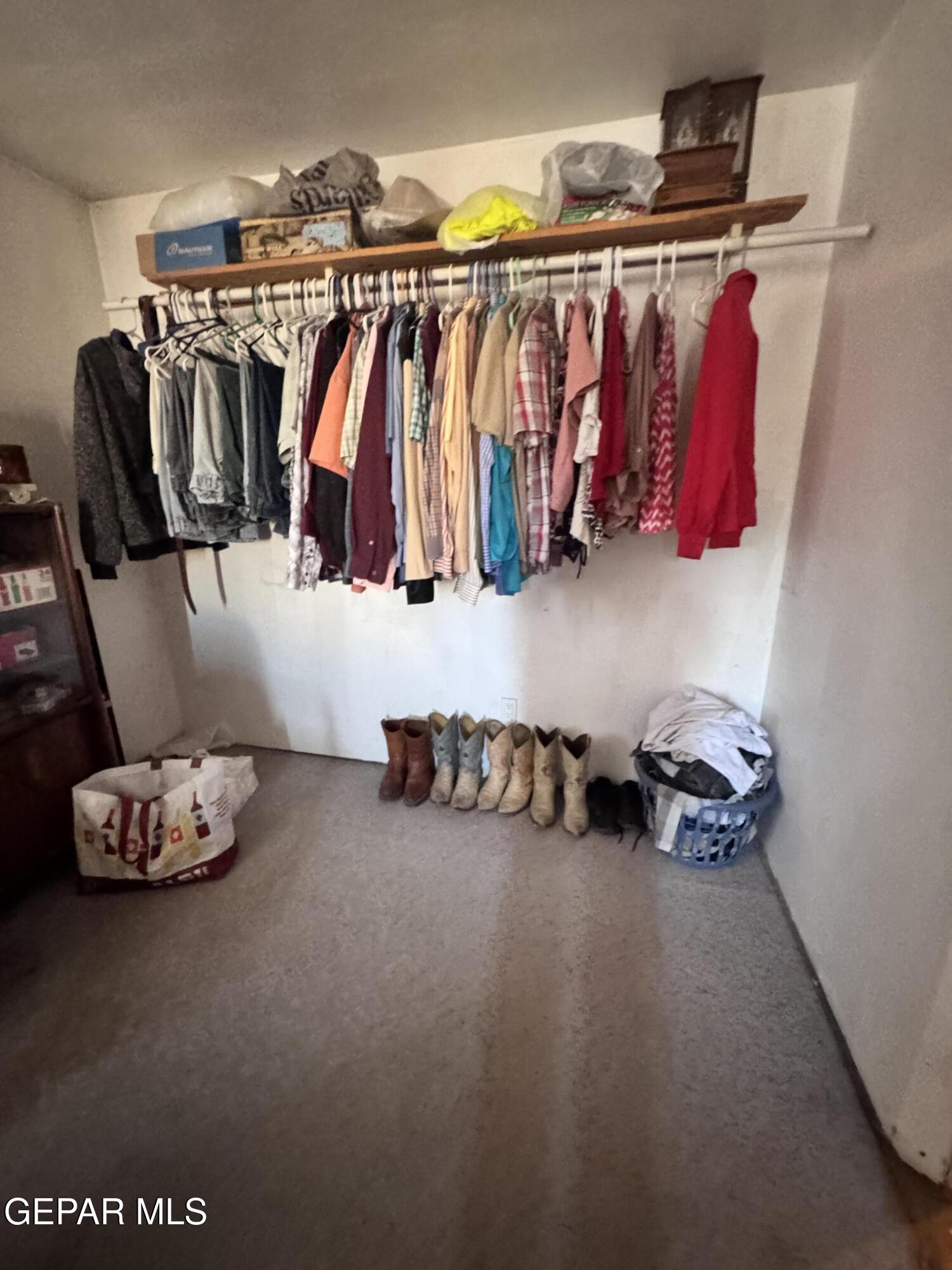 7045 1st Street Canutillo, TX 79835 - Photo 11 of 50 a view of walk in closet with clothes and shoes