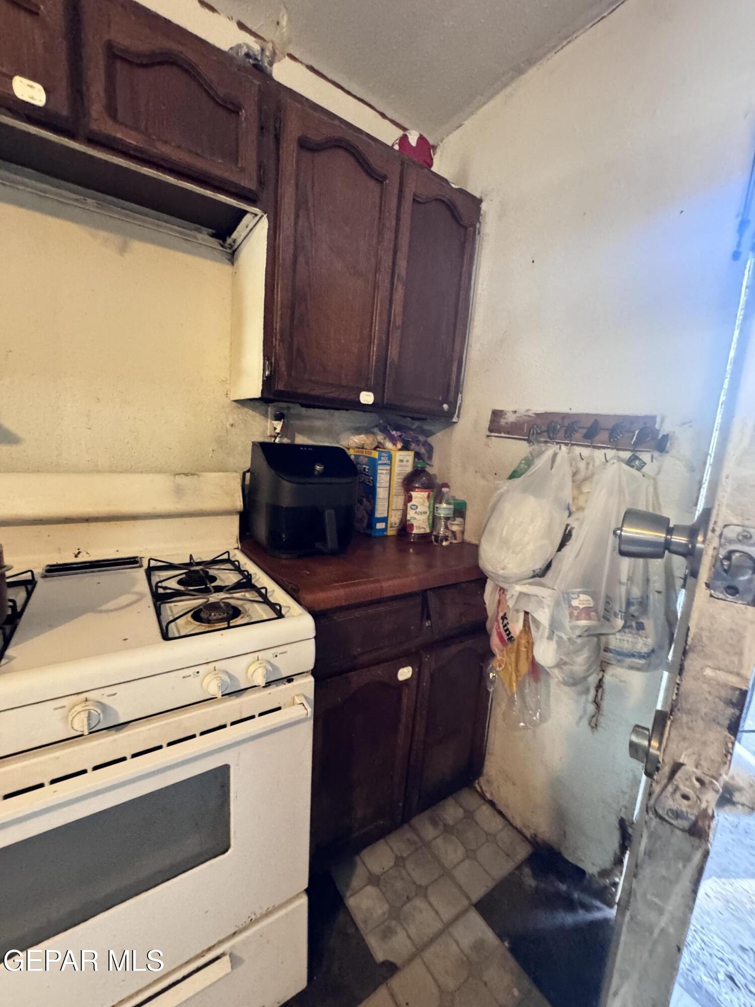 7045 1st Street Canutillo, TX 79835 - Photo 18 of 50 a stove top oven sitting inside of a kitchen