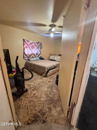 a view of a hallway with wooden floor and a bathroom