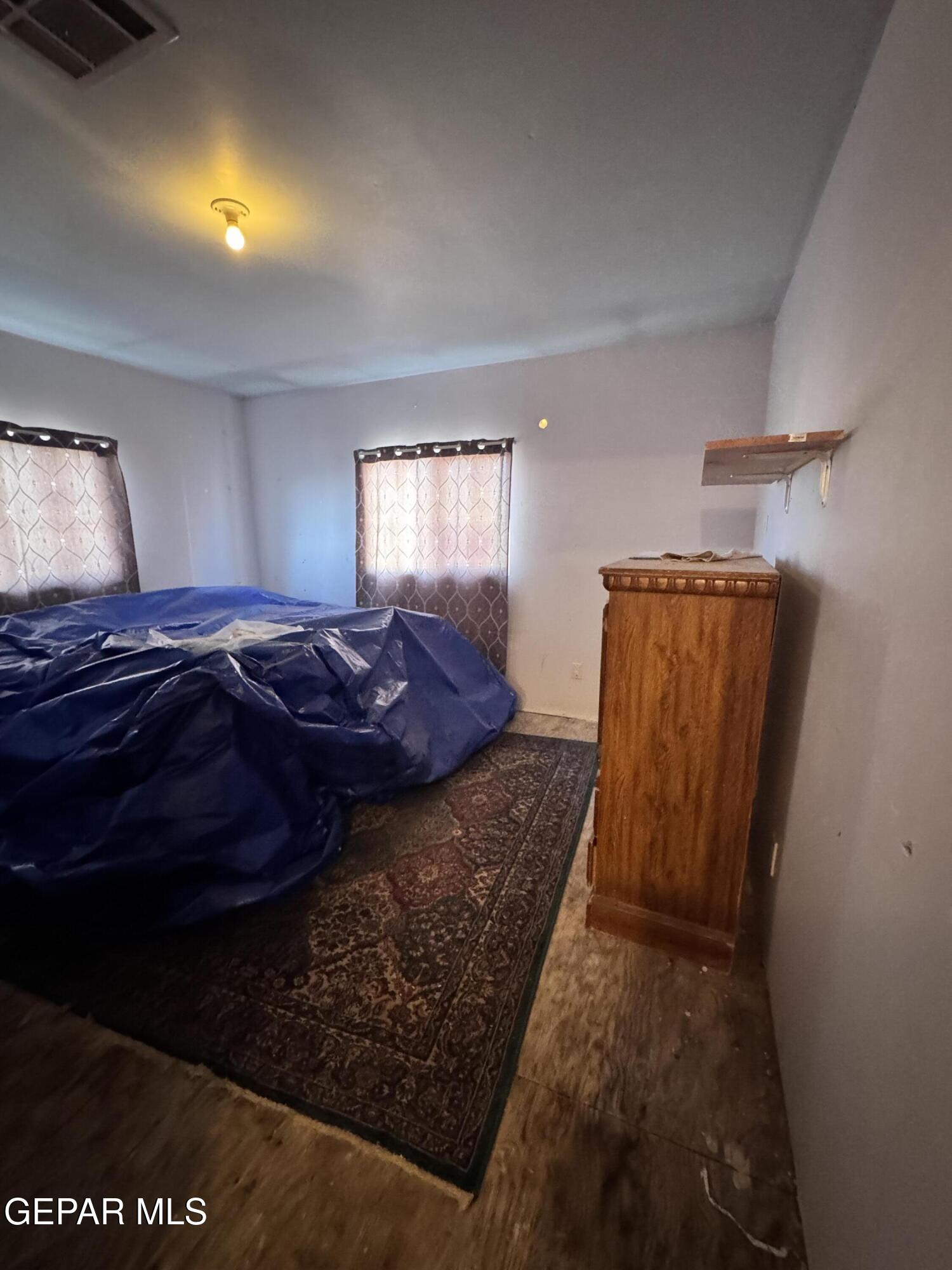 7045 1st Street Canutillo, TX 79835 - Photo 26 of 50 a bed sitting in a bedroom next to a window
