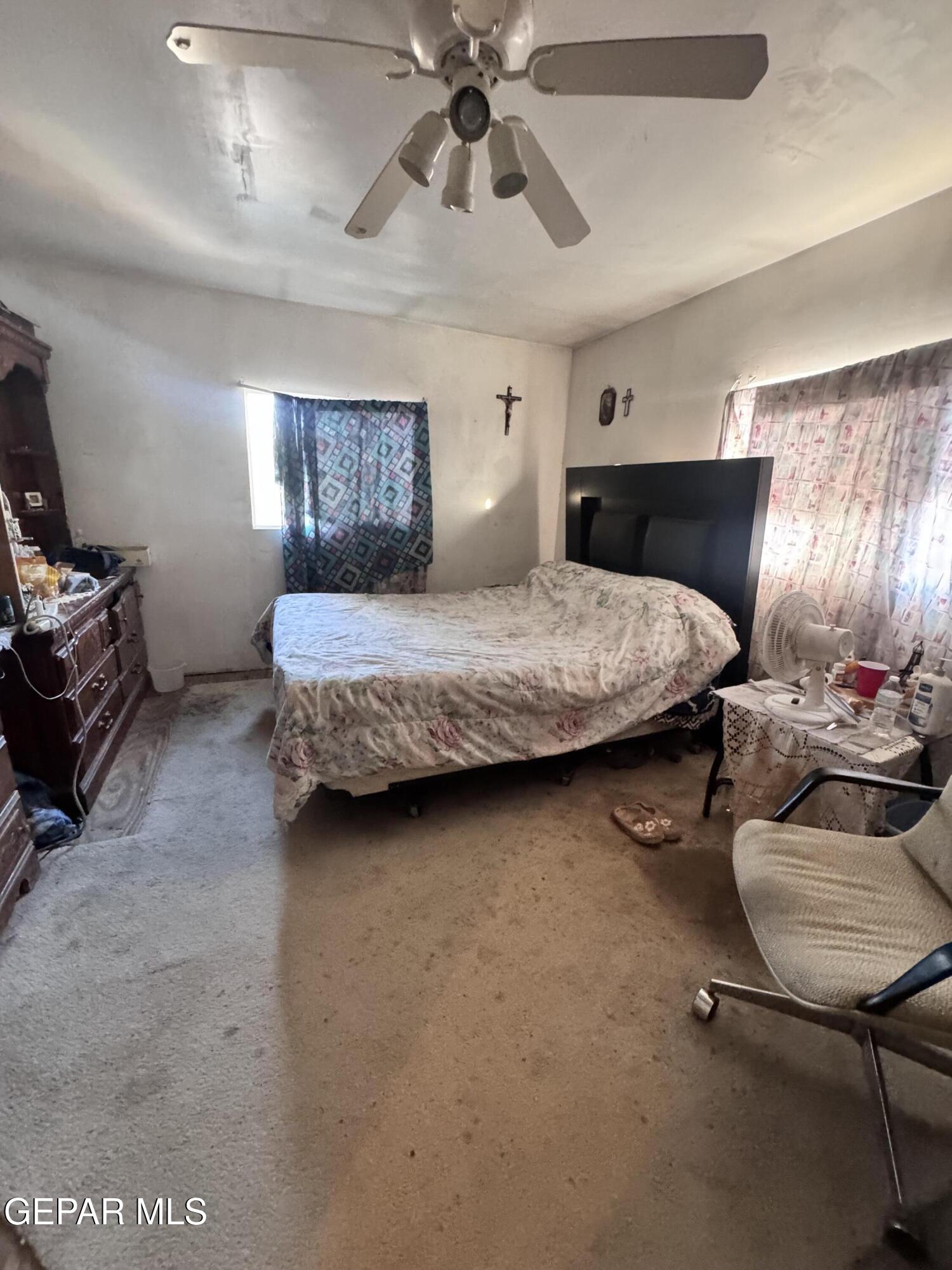7045 1st Street Canutillo, TX 79835 - Photo 27 of 50 a bedroom with a bed and ceiling fan