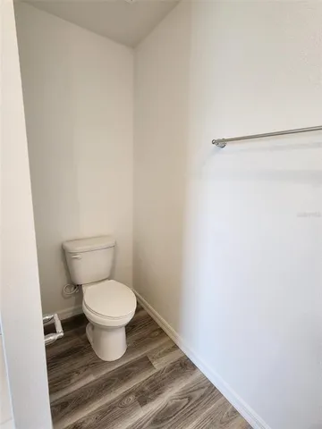 a white toilet sitting next to a shower