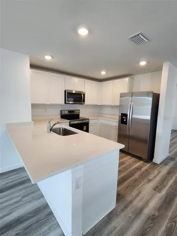 a kitchen with wooden cabinets and stainless steel appliances