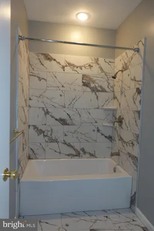 a bathroom with a bathtub and shower