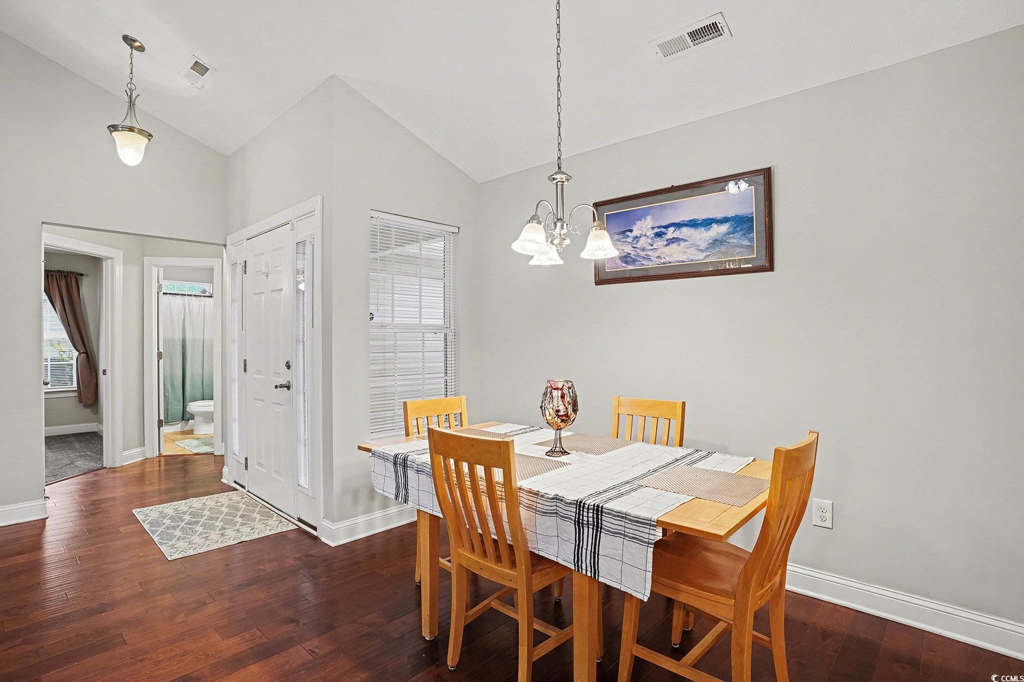 216 Camrose Way Myrtle Beach, SC 29588 - Photo 15 of 32 Dining room featuring dark wood finished floors, a chandelier, and high vaulted ceiling