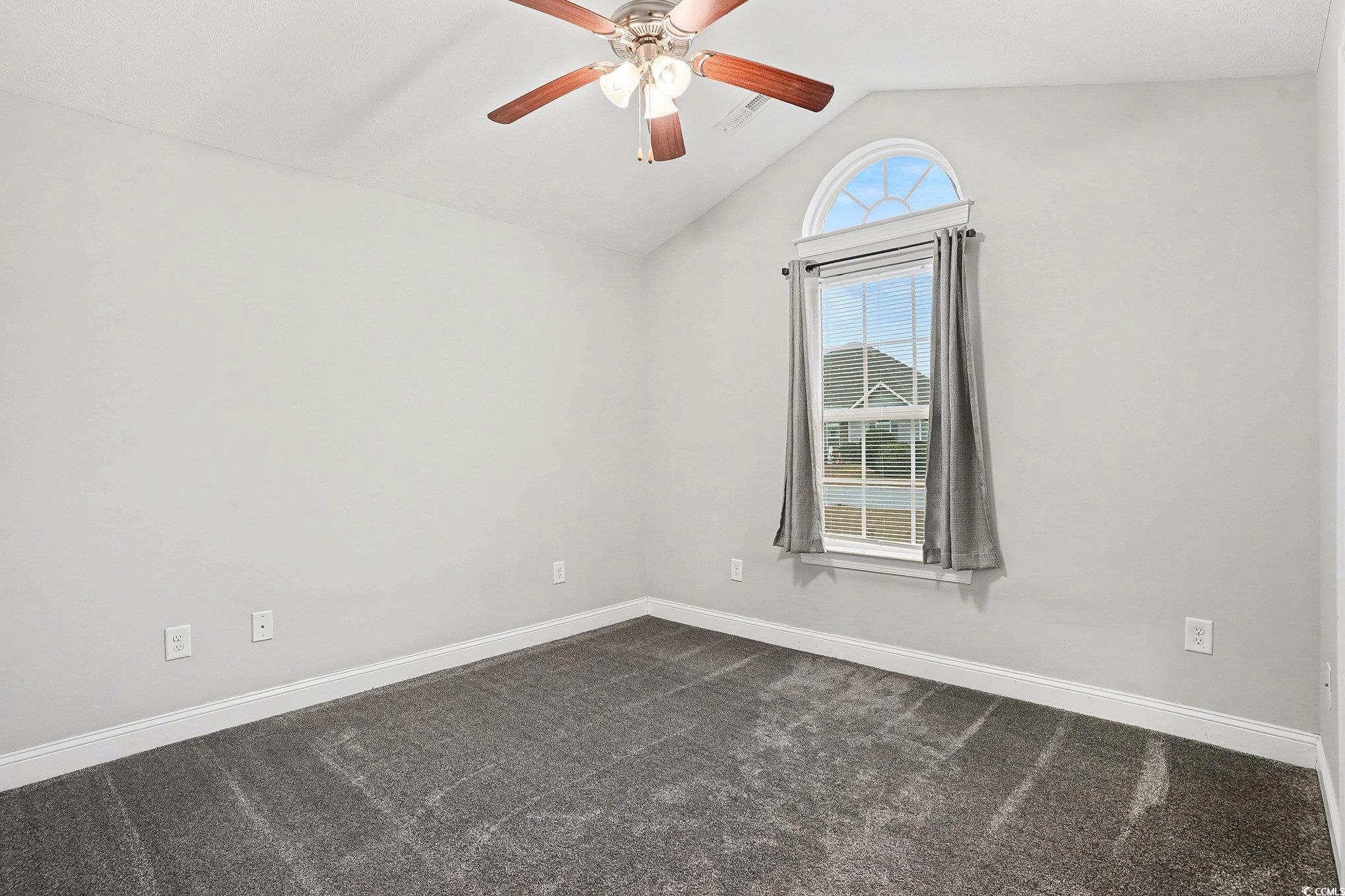 216 Camrose Way Myrtle Beach, SC 29588 - Photo 20 of 32 Unfurnished room featuring vaulted ceiling, dark colored carpet, and ceiling fan