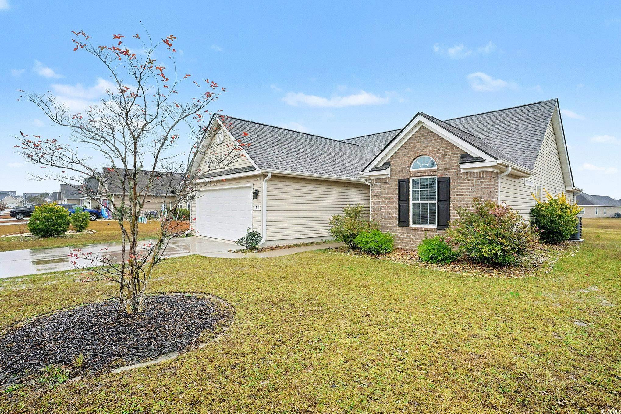 216 Camrose Way Myrtle Beach, SC 29588 - Photo 2 of 32 View of front facade with concrete driveway, brick siding, and a front yard