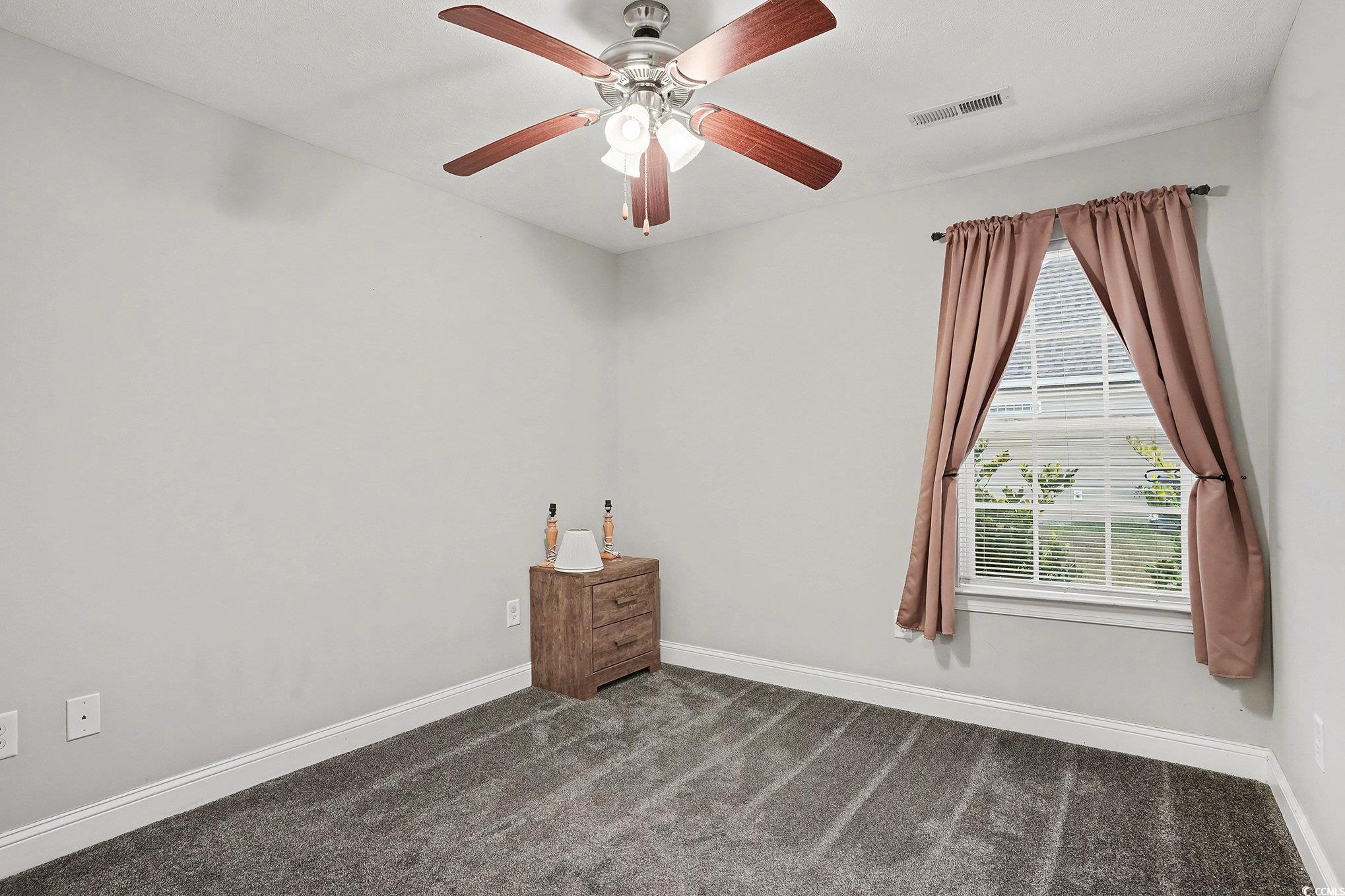 216 Camrose Way Myrtle Beach, SC 29588 - Photo 23 of 32 Empty room featuring dark colored carpet and ceiling fan