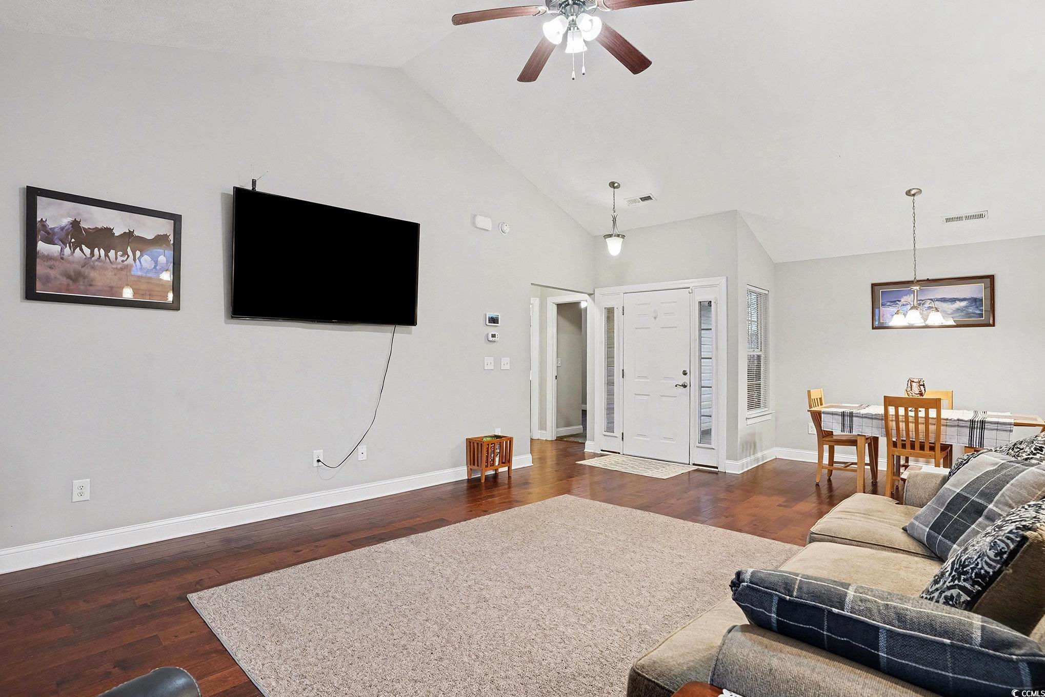 216 Camrose Way Myrtle Beach, SC 29588 - Photo 4 of 32 Living area with dark wood-style flooring, high vaulted ceiling, and a ceiling fan