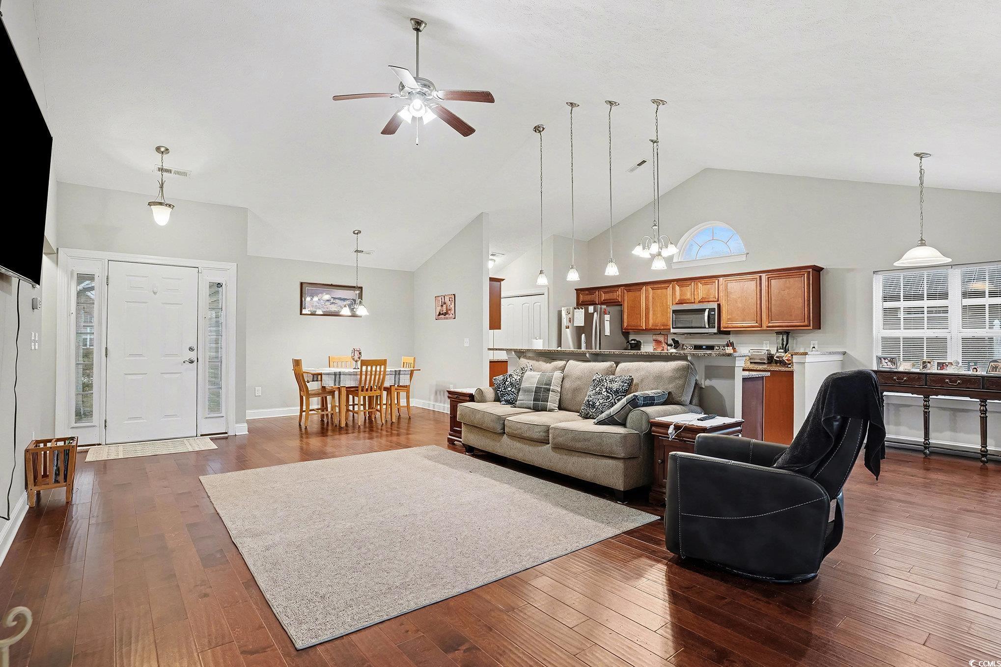 216 Camrose Way Myrtle Beach, SC 29588 - Photo 5 of 32 Living room with high vaulted ceiling, ceiling fan, a chandelier, and dark wood-type flooring