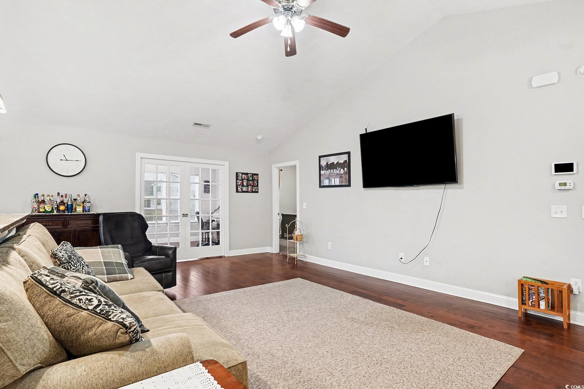216 Camrose Way Myrtle Beach, SC 29588 - Photo 6 of 32 Living room with french doors, vaulted ceiling, dark wood finished floors, and a ceiling fan