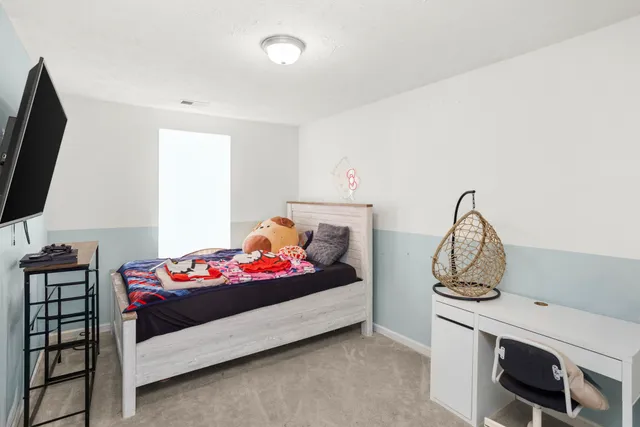 a bedroom with furniture and a flat screen tv