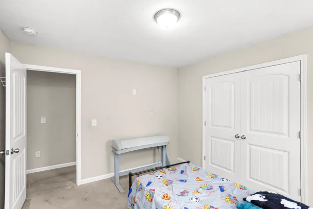 a bedroom with a bed and a lamp