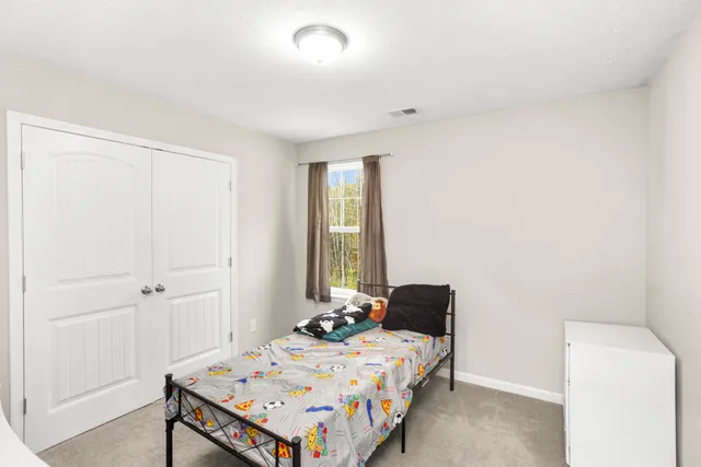 a bedroom with a bed and a table in it