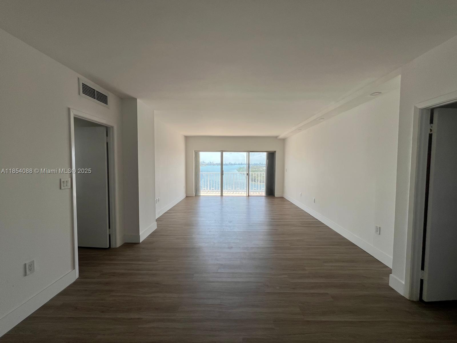 500 Bayview Drive, Unit 1120 Sunny Isles Beach, FL 33160 - Photo 15 of 46 a view of an empty room with wooden floor and a window