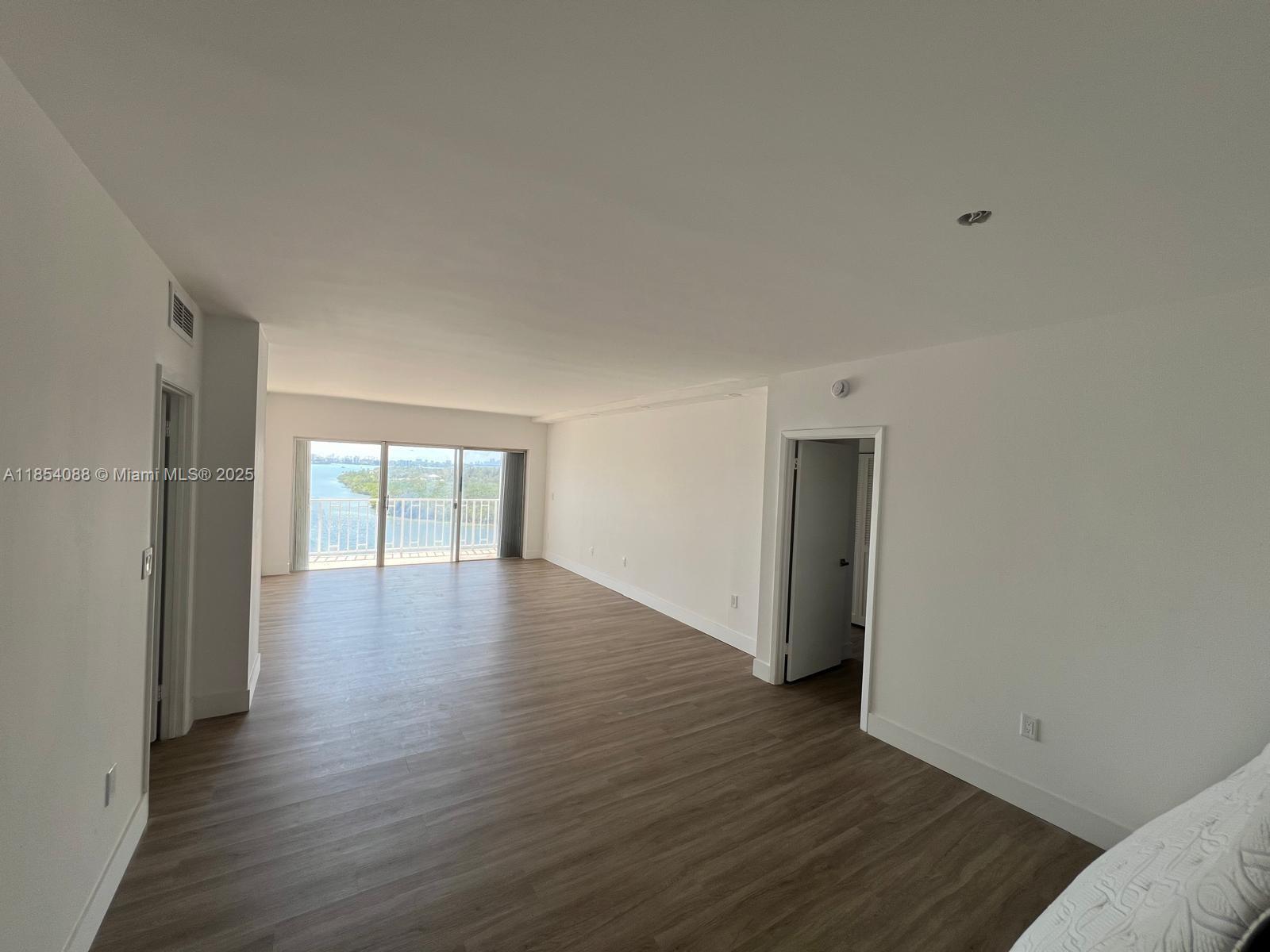 500 Bayview Drive, Unit 1120 Sunny Isles Beach, FL 33160 - Photo 18 of 46 a view of an empty room with wooden floor and a window
