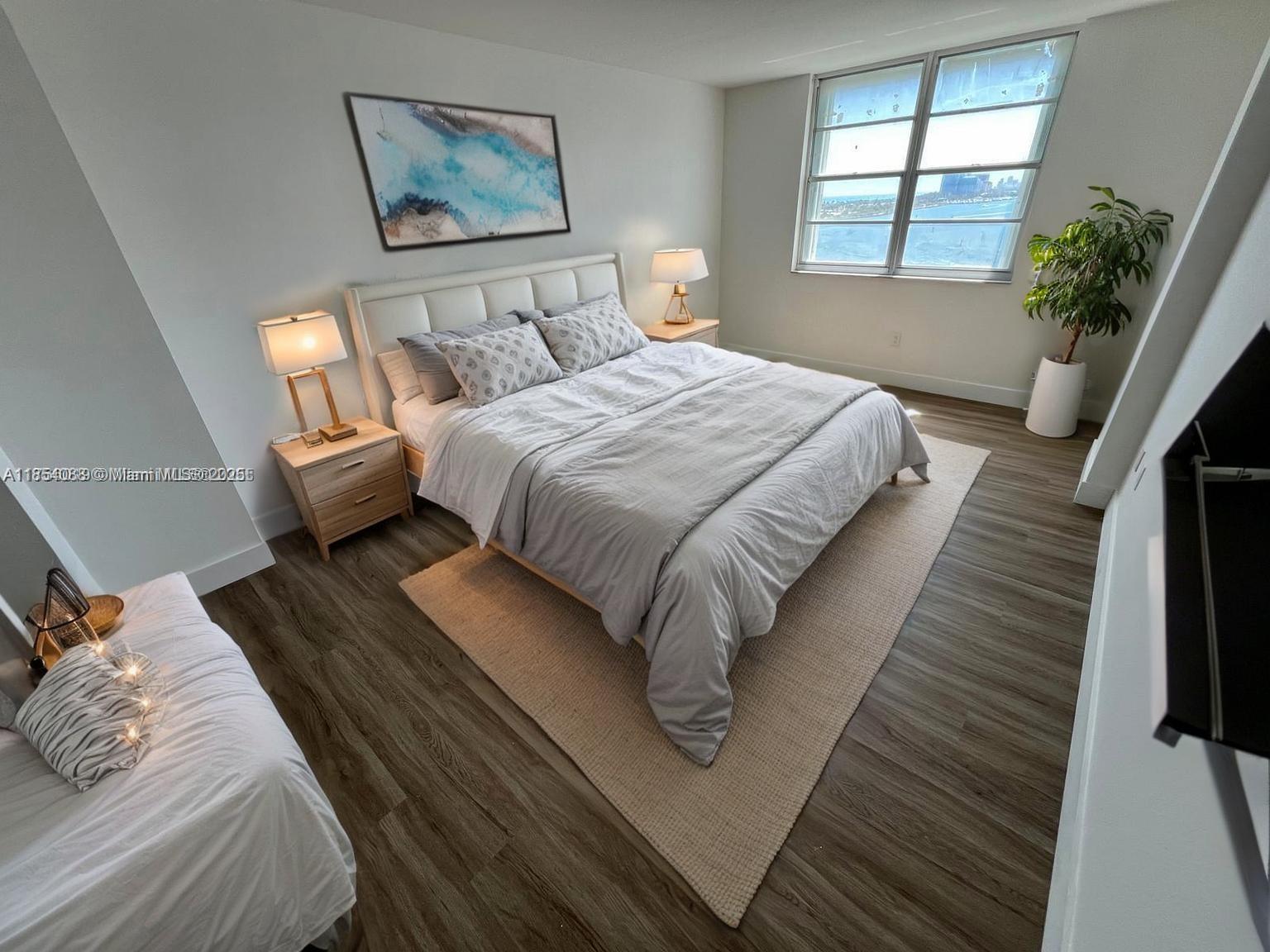 500 Bayview Drive, Unit 1120 Sunny Isles Beach, FL 33160 - Photo 20 of 46 a bedroom with bed and window