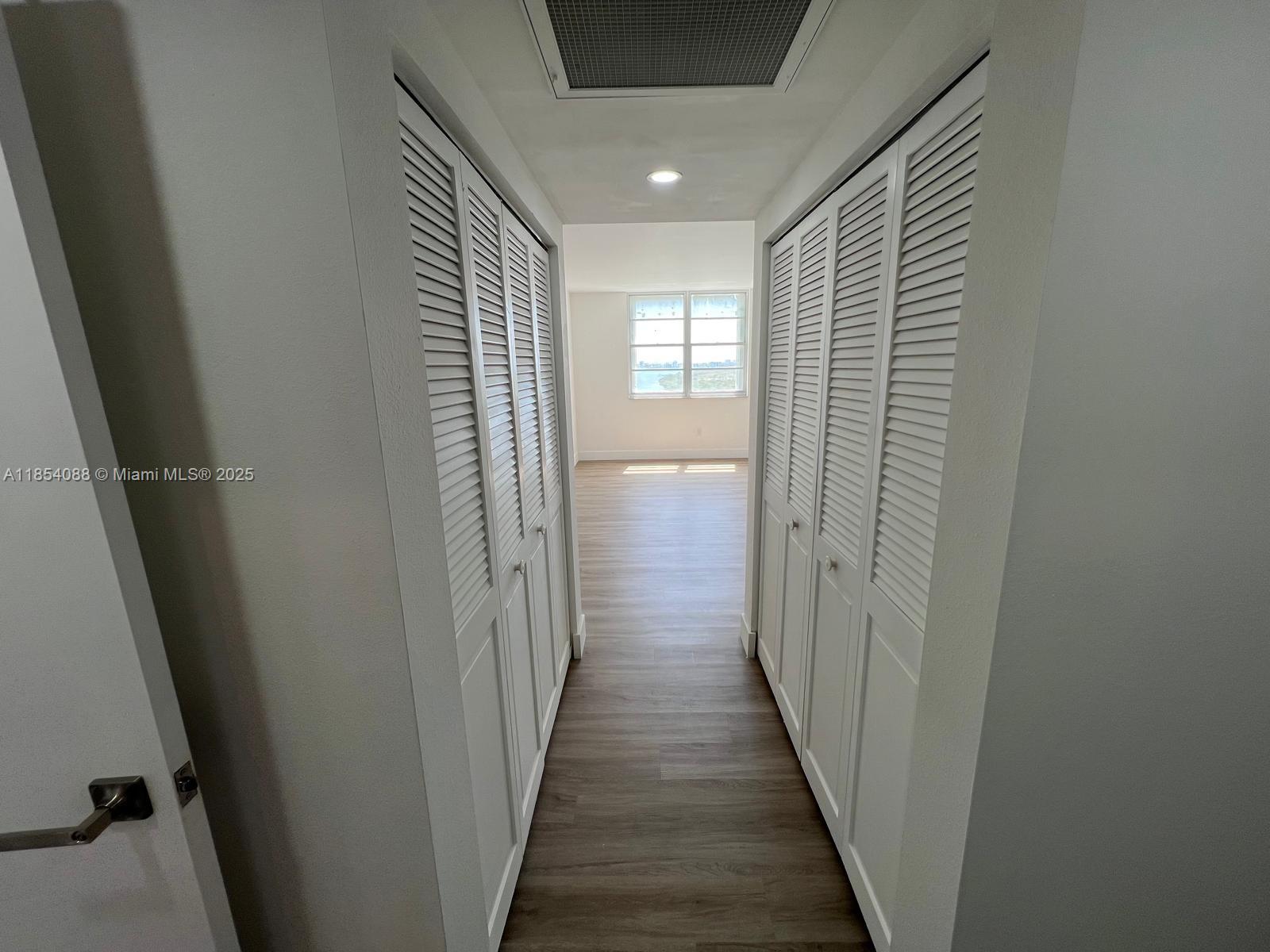 500 Bayview Drive, Unit 1120 Sunny Isles Beach, FL 33160 - Photo 27 of 46 a view of a hallway with wooden floor and staircase