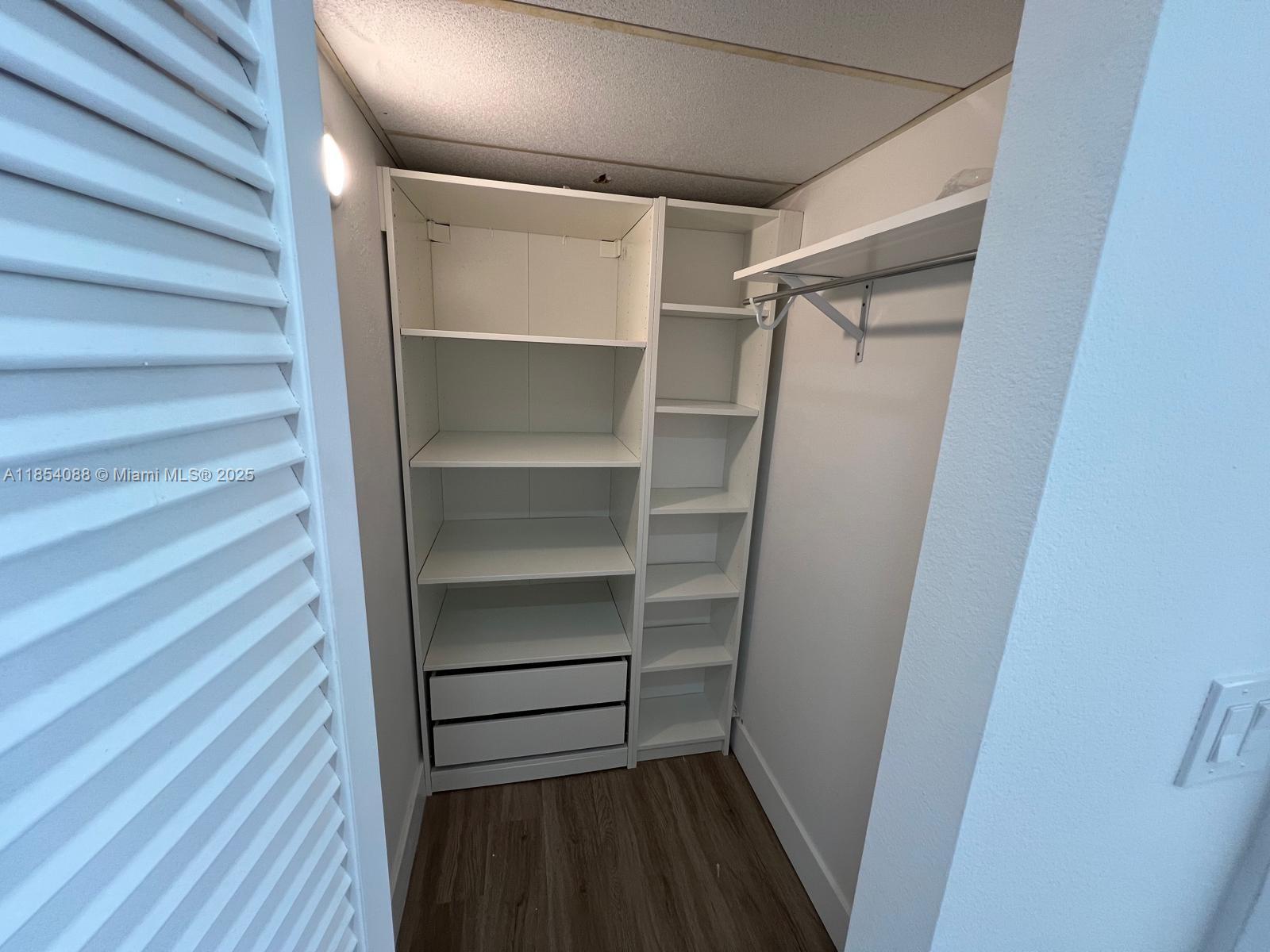 500 Bayview Drive, Unit 1120 Sunny Isles Beach, FL 33160 - Photo 28 of 46 a view of walk in closet with empty racks
