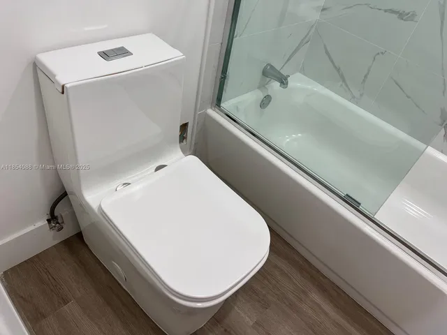 a bathroom with a shower and toilet