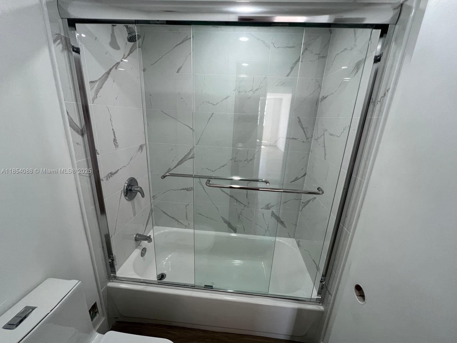 500 Bayview Drive, Unit 1120 Sunny Isles Beach, FL 33160 - Photo 31 of 46 a bathroom with a shower and toilet