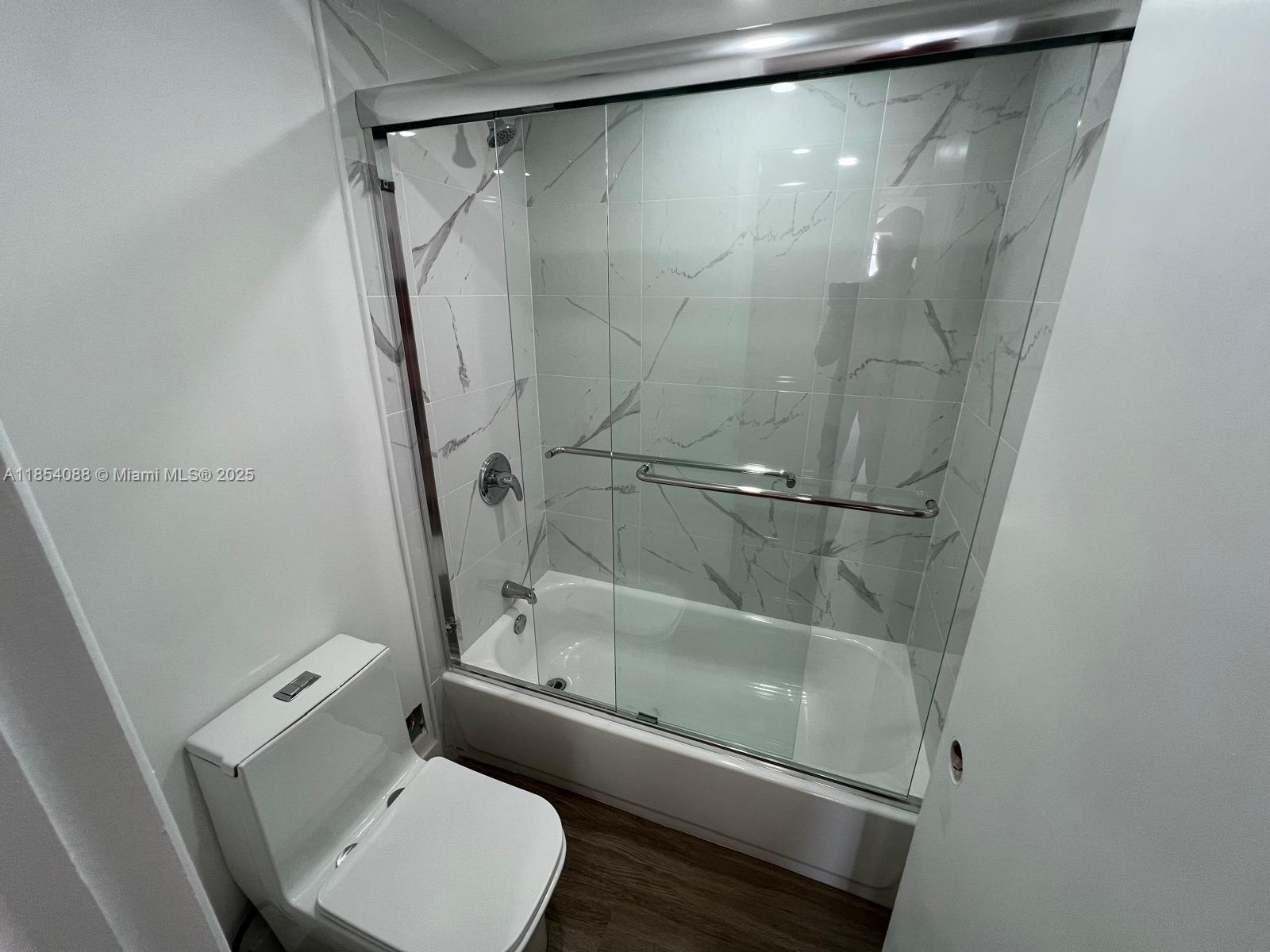 500 Bayview Drive, Unit 1120 Sunny Isles Beach, FL 33160 - Photo 32 of 46 a bathroom with a toilet and a shower