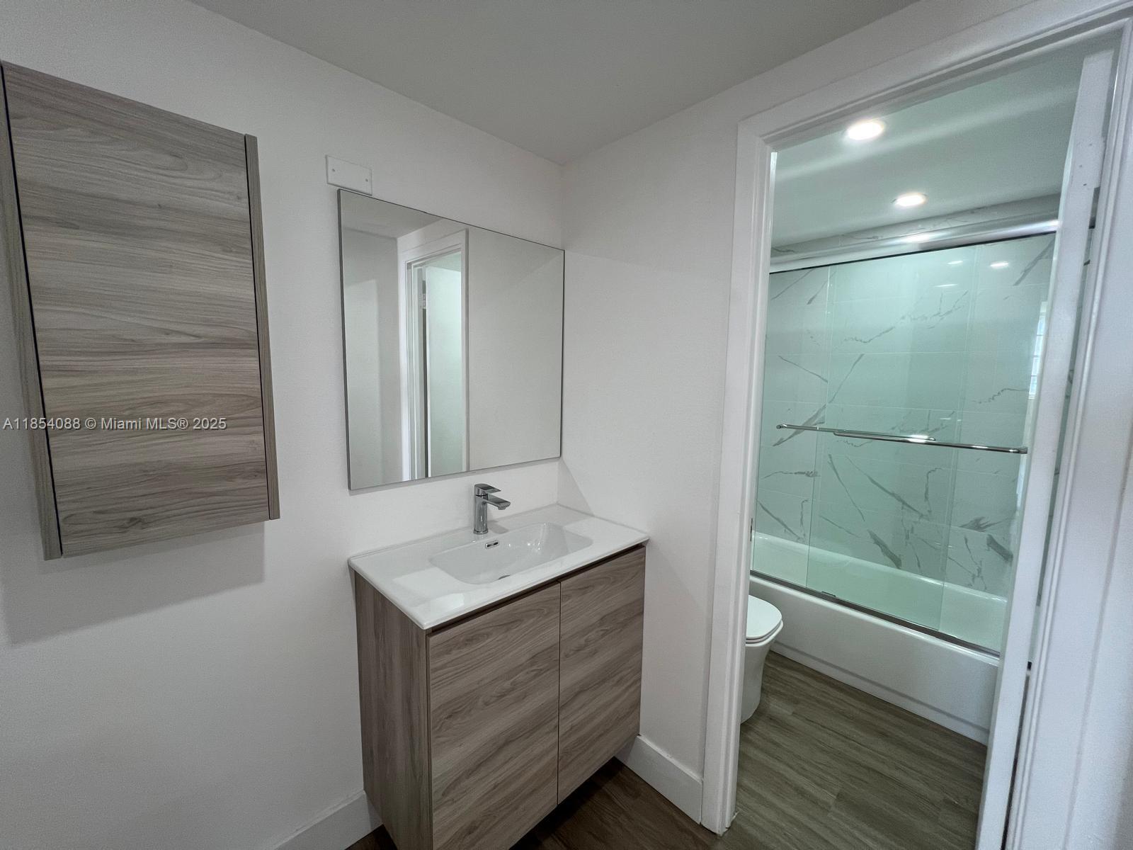 500 Bayview Drive, Unit 1120 Sunny Isles Beach, FL 33160 - Photo 33 of 46 a bathroom with a shower sink and mirror