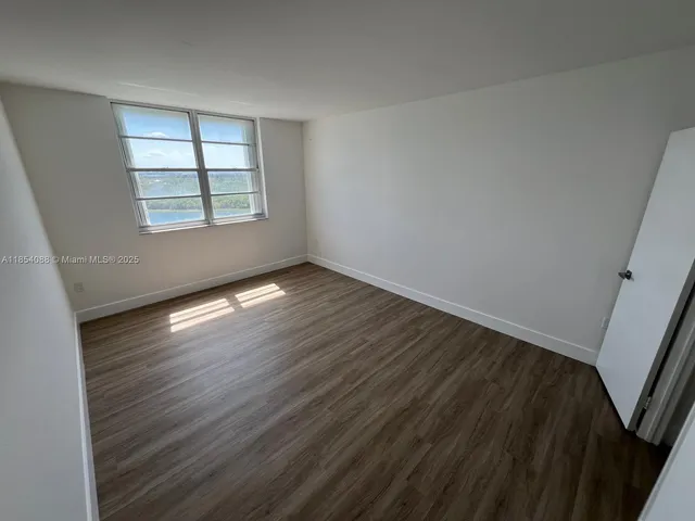 a view of storage and utility room with wooden floor