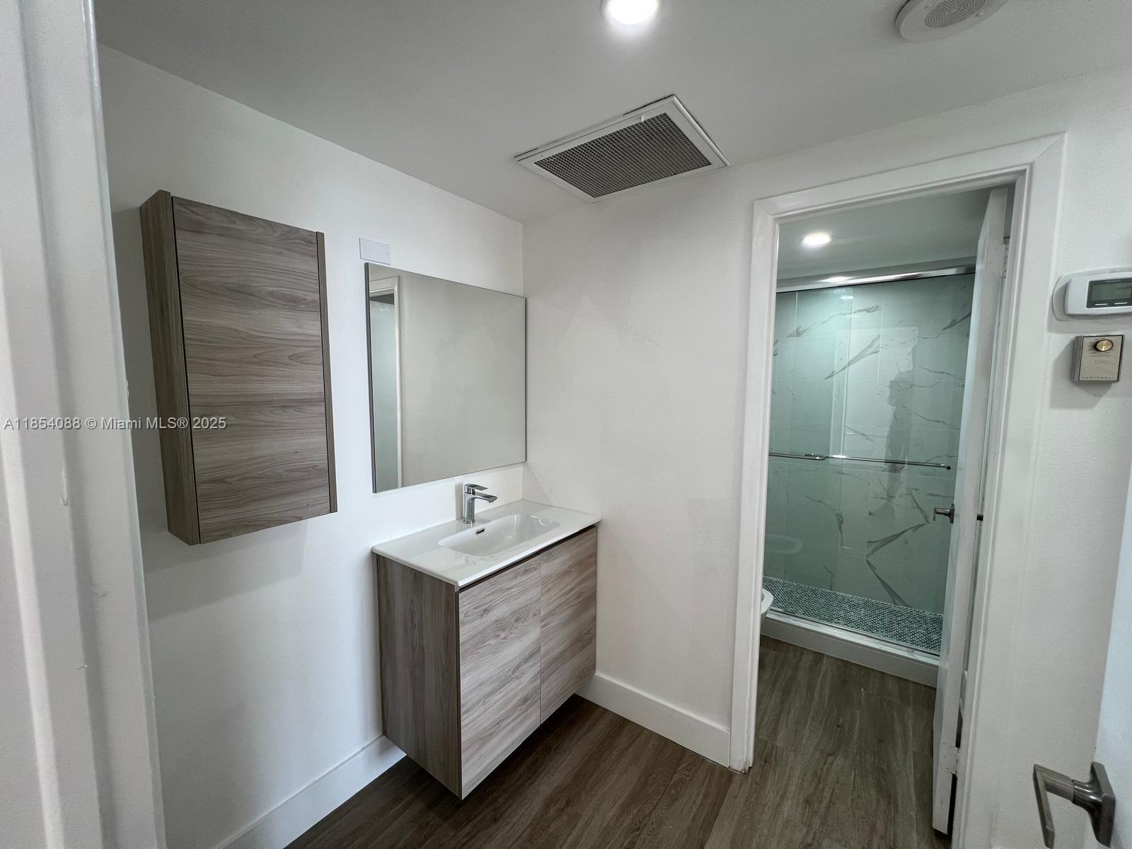 500 Bayview Drive, Unit 1120 Sunny Isles Beach, FL 33160 - Photo 40 of 46 a bathroom with a sink and mirror