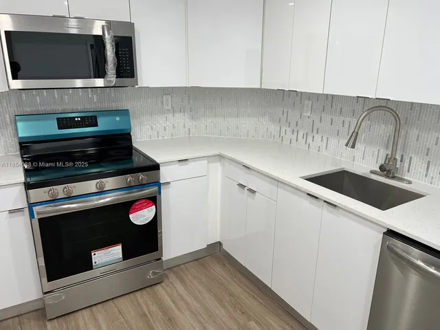 a kitchen with a stove and a microwave