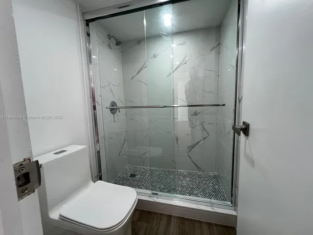 a bathroom with a shower and a toilet